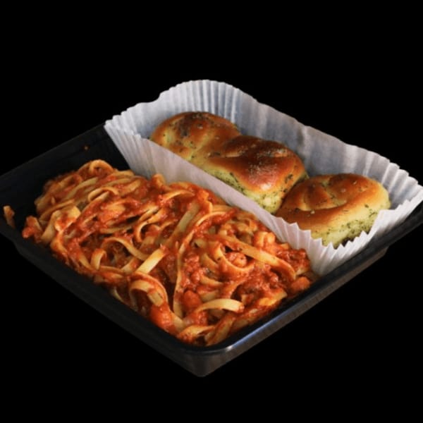 Casa Mia's fettuccine pasta with red sauce and two garlic knots in a black takeout container.